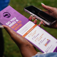 New Georgia Project canvasser Kayla McCall holds informational door hangers about the upcoming primary election on May 23, 2022, in East Point, Georgia. - Under slate gray skies in an African American neighborhood on the southwestern outskirts of Atlanta,
